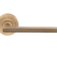 Trentino Door Handles On Round Rose, Antique Brass (sold in pairs)