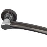Arkus Door Handles On Round Rose, Dual Finish Polished Chrome & Black Nickel