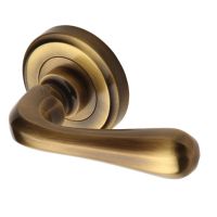 Heritage Brass Charlbury Antique Brass Door Handles On Round Rose (sold in pairs)